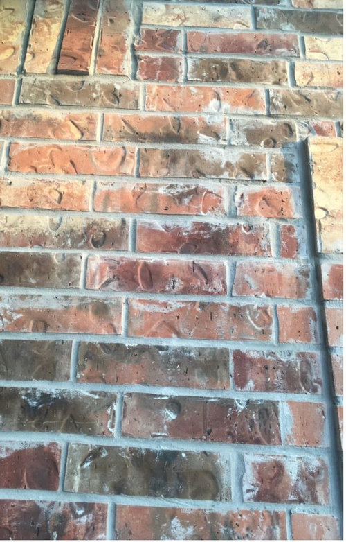 Grey mortar smeared on brick