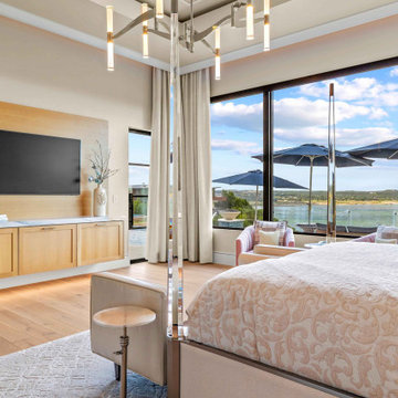 Primary Bedroom with Custom Media Wall and Lake Views