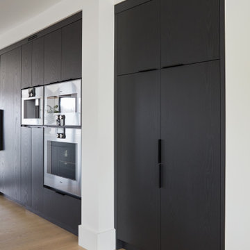 Modern Black Kitchen with Wall Ovens & Tall Pantry
