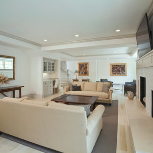 Imagen de sótano con ventanas tradicional renovado, grande, con paredes blancas, suelo de madera clara, chimenea tradicional, marco de chimenea de baldosas y/o azulejos y suelo beige