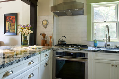 Eat-in kitchen - small transitional u-shaped medium tone wood floor eat-in kitchen idea in Denver with a single-bowl sink, recessed-panel cabinets, white cabinets, marble countertops, white backsplash, ceramic backsplash, stainless steel appliances and a peninsula