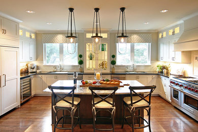 Inspiration for a large transitional medium tone wood floor kitchen remodel in Houston with an undermount sink, recessed-panel cabinets and an island