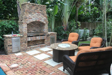 Inspiration for a patio in Miami with an outdoor kitchen and brick pavers.