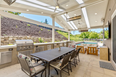 This is an example of a large contemporary back patio in San Francisco with an outdoor kitchen.