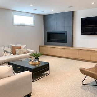 This is an example of a medium sized classic fully buried basement in Other with white walls, carpet, a standard fireplace, a tiled fireplace surround and beige floors.