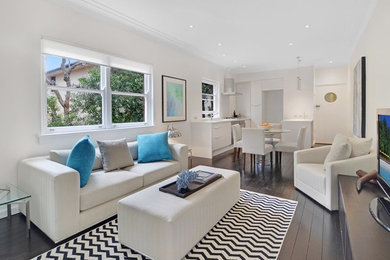 Inspiration for a coastal open concept living room remodel in Sydney with white walls and a tv stand