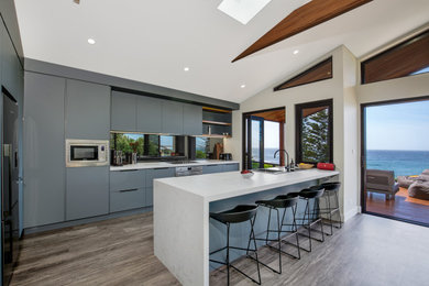 Inspiration for a modern kitchen in Other with quartz benchtops, mirror splashback and stainless steel appliances.