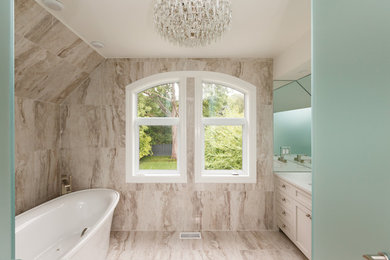 Inspiration for a large transitional master beige tile and porcelain tile porcelain tile and beige floor bathroom remodel in Toronto with shaker cabinets, white cabinets, a two-piece toilet, beige walls, an undermount sink, quartz countertops and a hinged shower door