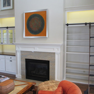 Custom bookcase and built-in with black walnut counter-tops and glass shelving