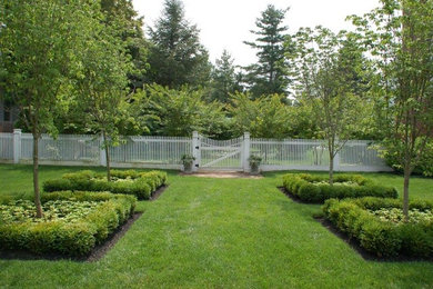 Photo of a large traditional partial sun front yard mulch landscaping in New York for spring.