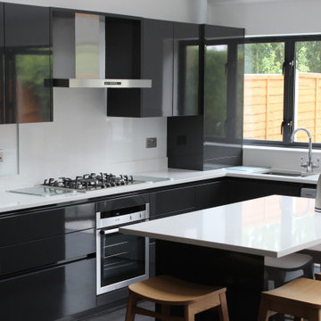 Sleek Modern Black Kitchen with Island by Kudos Interior Design