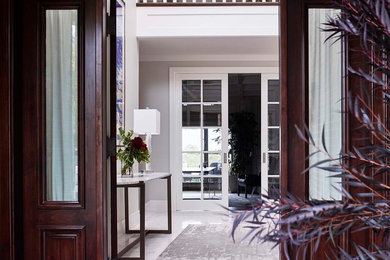 Photo of a large transitional foyer in San Francisco with a double front door and a dark wood front door.