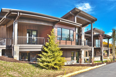 Photo of a large contemporary two-storey brown house exterior in Salt Lake City with wood siding and a shingle roof.