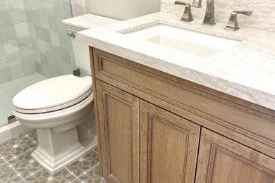 Example of a mid-sized country kids' beige tile and ceramic tile cement tile floor, blue floor, single-sink and wainscoting alcove shower design in Orange County with recessed-panel cabinets, brown cabinets, a two-piece toilet, beige walls, an undermount sink, solid surface countertops, a hinged shower door, beige countertops and a built-in vanity