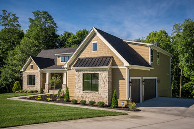 Inspiration for a large craftsman orange two-story mixed siding house exterior remodel in Louisville with a shingle roof