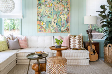 This is an example of a transitional living room in San Diego with green walls, medium hardwood floors and planked wall panelling.