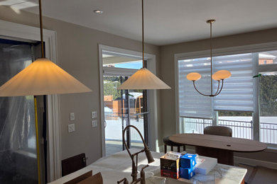 Beach style dark wood floor, brown floor, coffered ceiling and wall paneling kitchen/dining room combo photo in Montreal with beige walls
