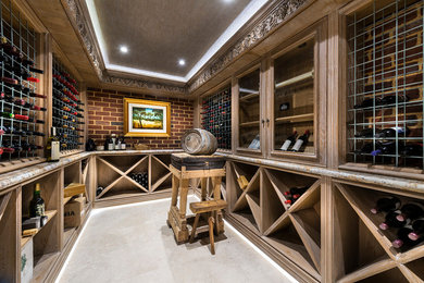 This is an example of a large mediterranean wine cellar in Perth with slate floors and display racks.