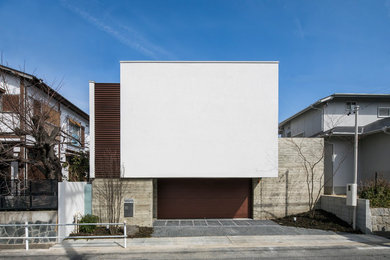 Example of a mid-sized minimalist white split-level house exterior design in Nagoya