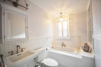 Mid-sized elegant gray floor drop-in bathtub photo in Richmond with a two-piece toilet, beige walls and a pedestal sink