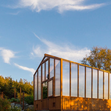 Contemporary deck with custom rails, decking, gate and greenhouse