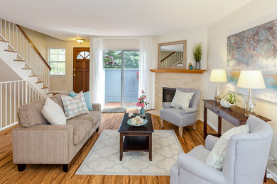 Living room - small coastal formal and enclosed medium tone wood floor living room idea in Los Angeles with beige walls, a corner fireplace, a brick fireplace and no tv