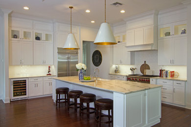 Eat-in kitchen - large transitional ceramic tile and brown floor eat-in kitchen idea in Tampa with a farmhouse sink, shaker cabinets, white cabinets, quartzite countertops, white backsplash, subway tile backsplash, stainless steel appliances and an island
