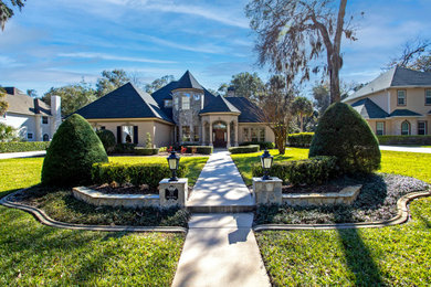 Example of a french country exterior home design in Orlando