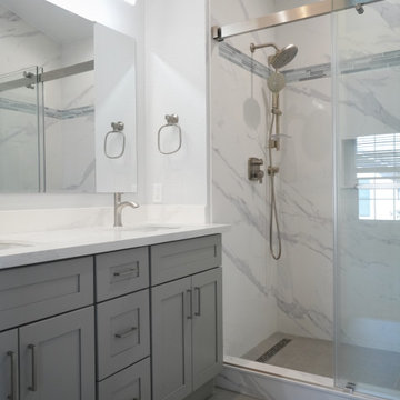 This modern kitchen remodel blends crisp white upper cabinetry with warm natural