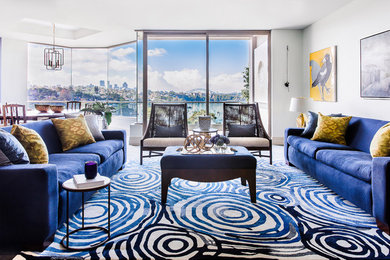 Photo of a large transitional formal open concept living room in Sydney with blue walls and carpet.