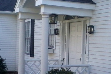 Example of a mid-sized white one-story vinyl exterior home design in New York