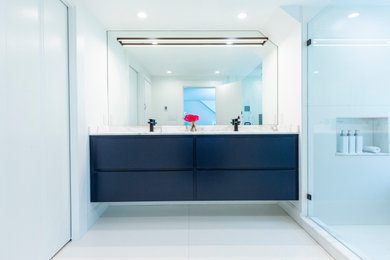 Bathroom - small transitional master porcelain tile, white floor and double-sink bathroom idea in Cincinnati with flat-panel cabinets, blue cabinets, white walls, marble countertops, white countertops and a floating vanity