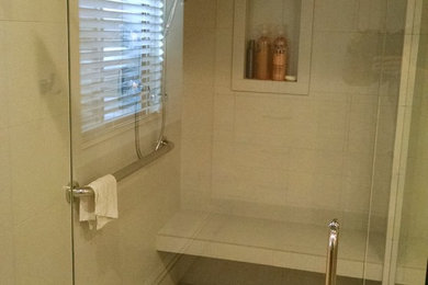 Example of a mid-sized minimalist pebble tile and beige tile pebble tile floor corner shower design in Salt Lake City with beige walls