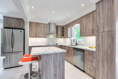 Design ideas for a mid-sized l-shaped kitchen in Toronto with an undermount sink, shaker cabinets, dark wood cabinets, quartzite benchtops, white splashback, porcelain splashback, stainless steel appliances, porcelain floors, with island, white floor and white benchtop.