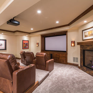 Elegant open concept carpeted and beige floor home theater photo in Denver with beige walls and a projector screen