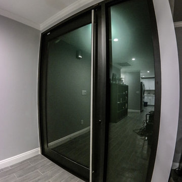 Custom Anodized Aluminum Front Door with Smoked Glass. Door swings In & Out.