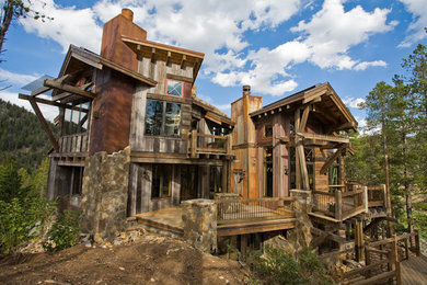 Huge mountain style three-story mixed siding gable roof photo in Denver