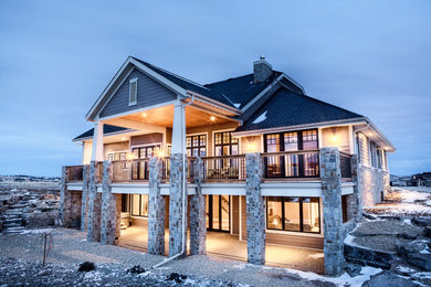 Example of a large arts and crafts brown two-story concrete fiberboard gable roof design in Calgary