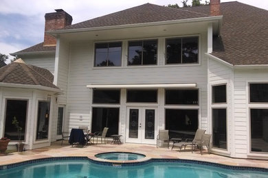 Traditional white two-story wood exterior home idea in Houston