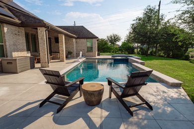 Example of a mid-sized trendy backyard stamped concrete and rectangular hot tub design in Houston