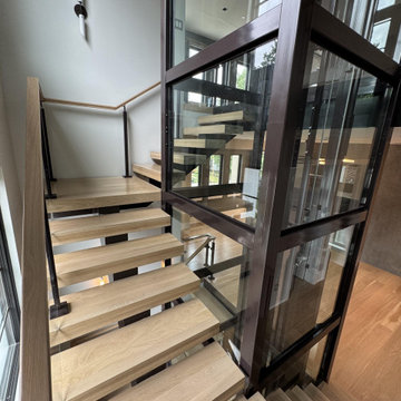 Project #136 | Modern Floating Staircase Encircling Glass Elevator