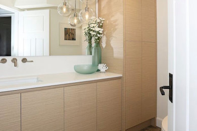 Inspiration for a small coastal 3/4 slate floor and beige floor bathroom remodel in Vancouver with flat-panel cabinets, light wood cabinets, a one-piece toilet, white walls, an undermount sink, quartz countertops and white countertops