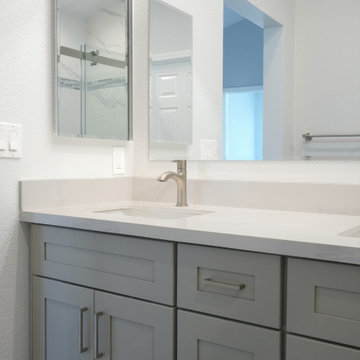 This modern kitchen remodel blends crisp white upper cabinetry with warm natural