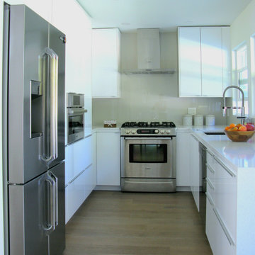 Glossy White Kitchen with Integrated Appliances – Upper Lonsdale Renovation
