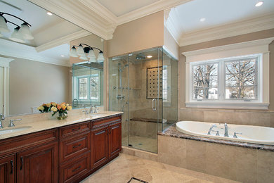 Inspiration for a large timeless master travertine floor bathroom remodel in San Diego with a two-piece toilet, raised-panel cabinets, dark wood cabinets, beige walls and an undermount sink