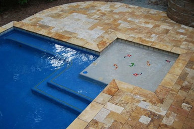 Pool - mid-sized backyard stone and rectangular pool idea in Other
