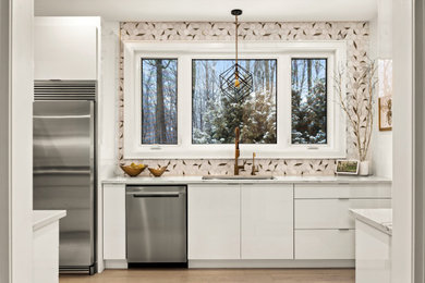 Mid-sized minimalist galley light wood floor and beige floor kitchen pantry photo in Toronto with an undermount sink, flat-panel cabinets, white cabinets, quartz countertops, white backsplash, mosaic tile backsplash, stainless steel appliances, no island and white countertops