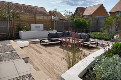 Design ideas for a large contemporary back ground level terrace in Surrey with a water feature.