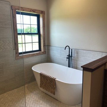 Master bath wet room freestanding tub with oil rubbed bronze floor faucet and he