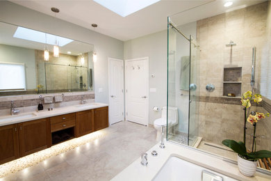 Design ideas for a mid-sized contemporary master bathroom in New York with recessed-panel cabinets, medium wood cabinets, an undermount tub, a corner shower, a one-piece toilet, an undermount sink, beige tile, ceramic tile, beige walls, ceramic floors, quartzite benchtops, beige floor and a hinged shower door.